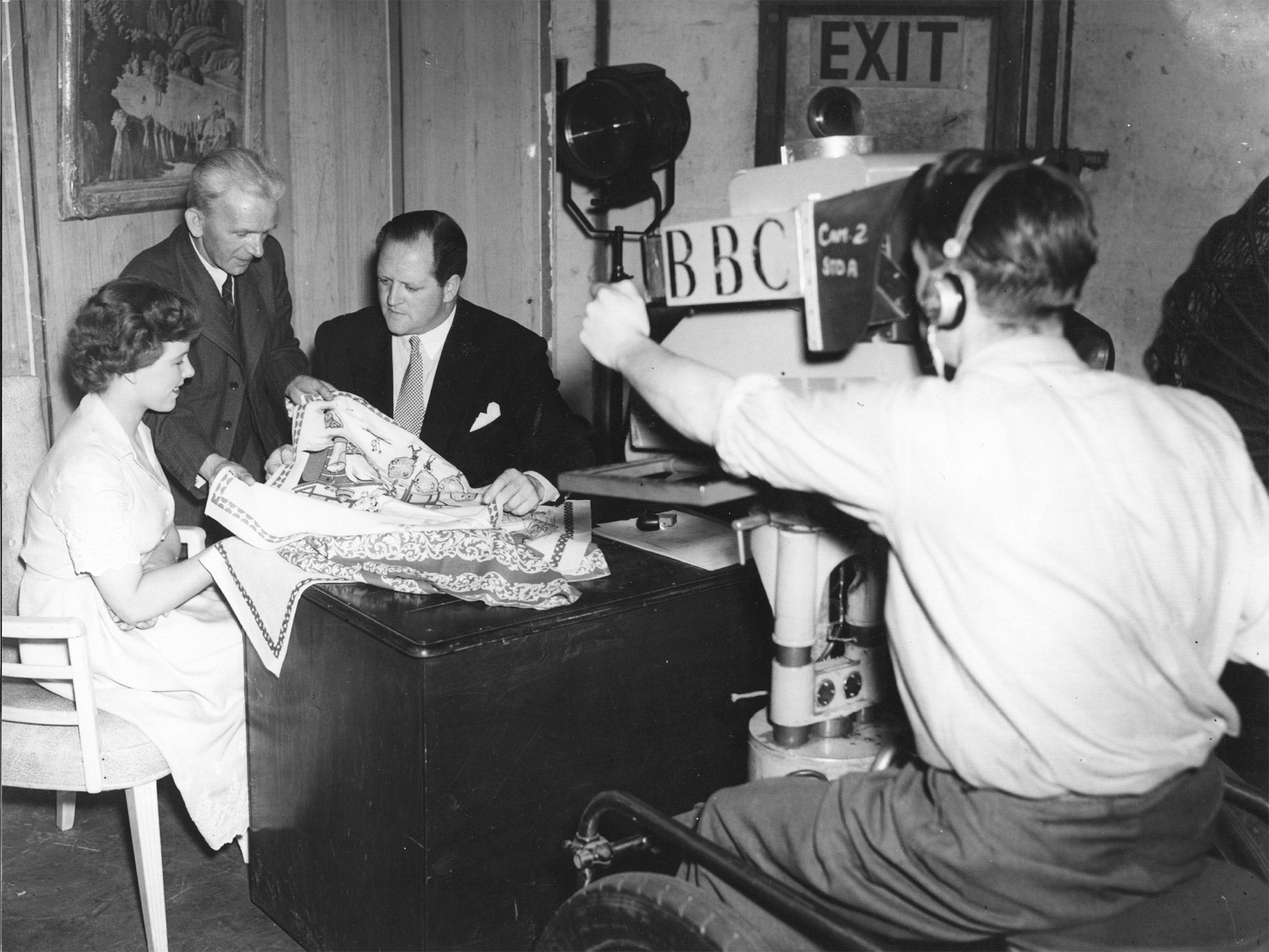 Broadcaster Richard Dimbleby talks to Irish linen workers for a BBC television programme in 1950 (Getty)