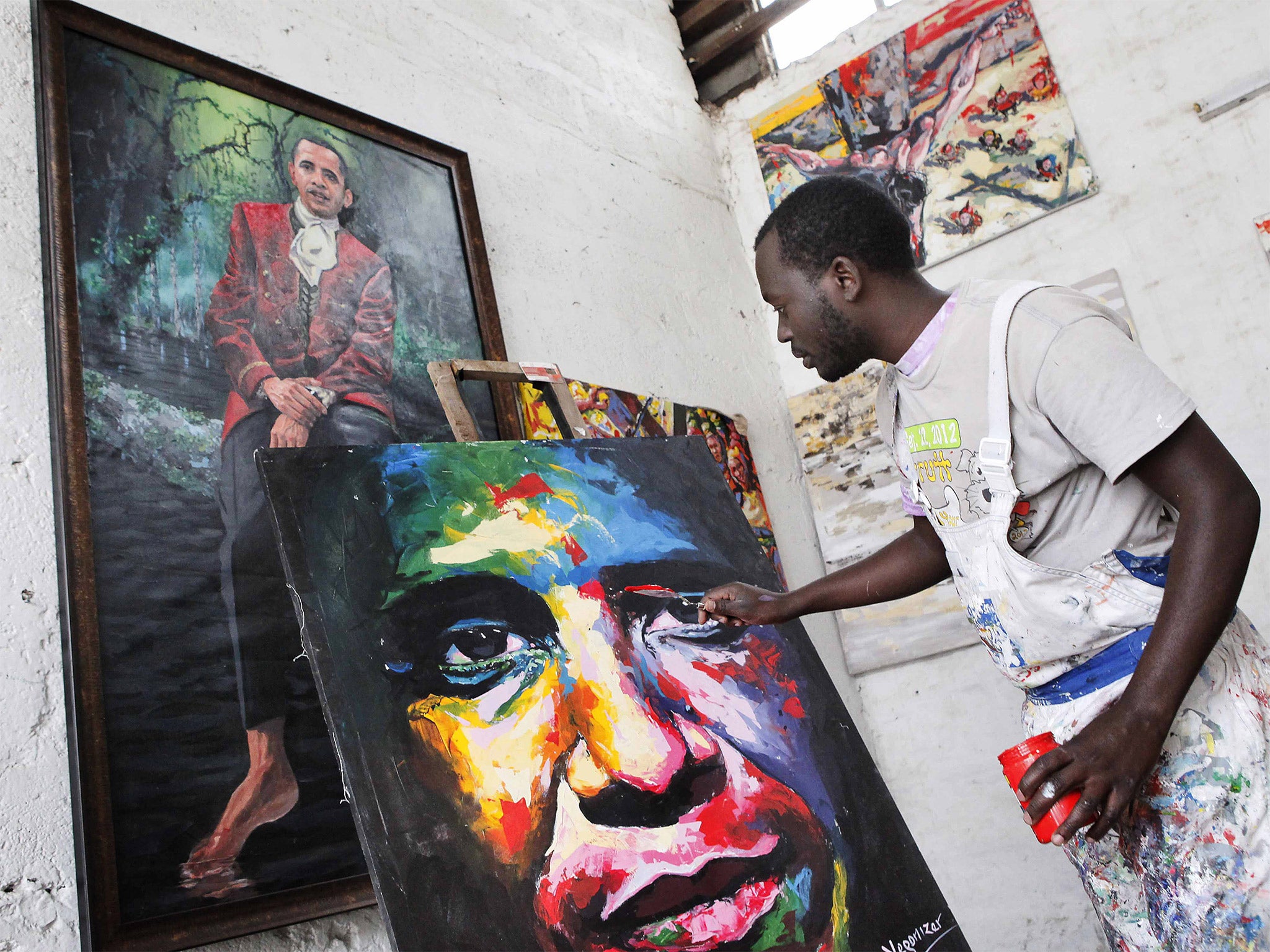 Artist Yegonizer works on a painting of Barack Obama ahead of his first visit to the country since his becoming President (Getty)