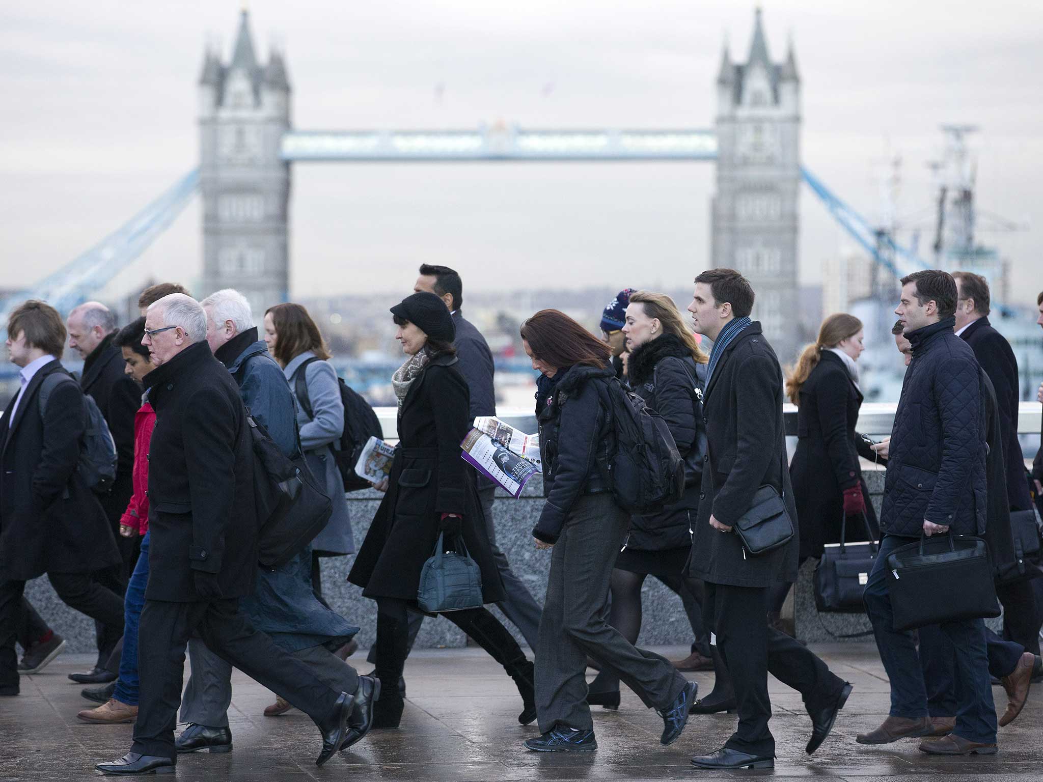 London commuters trudge past Tower Bridge