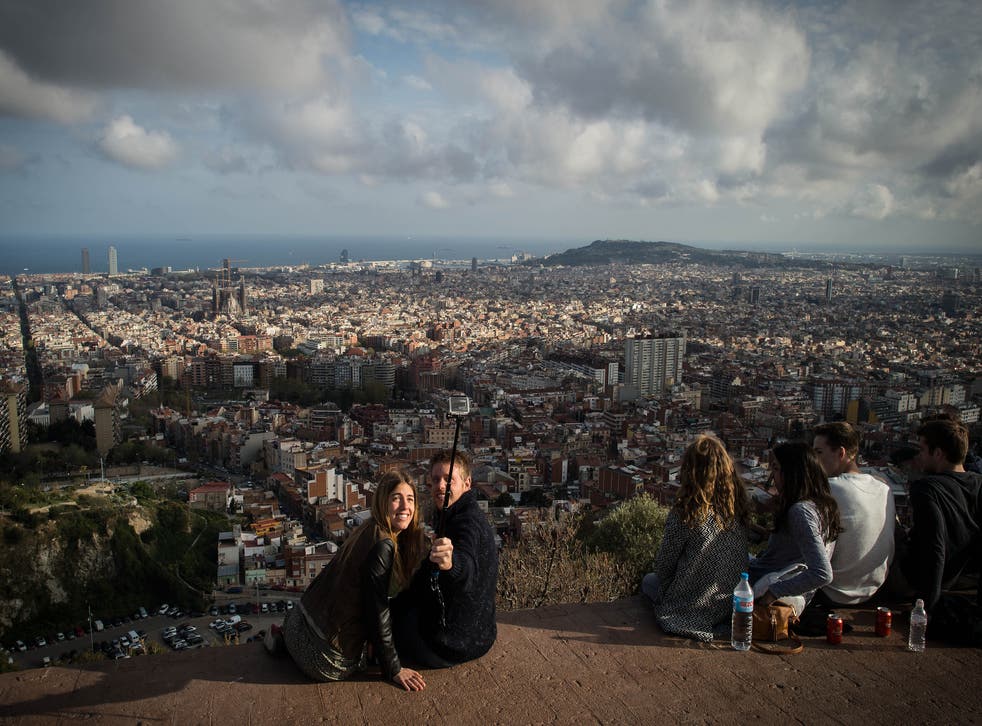 A couple take a selfie as they enjoy the views over Barcelona
