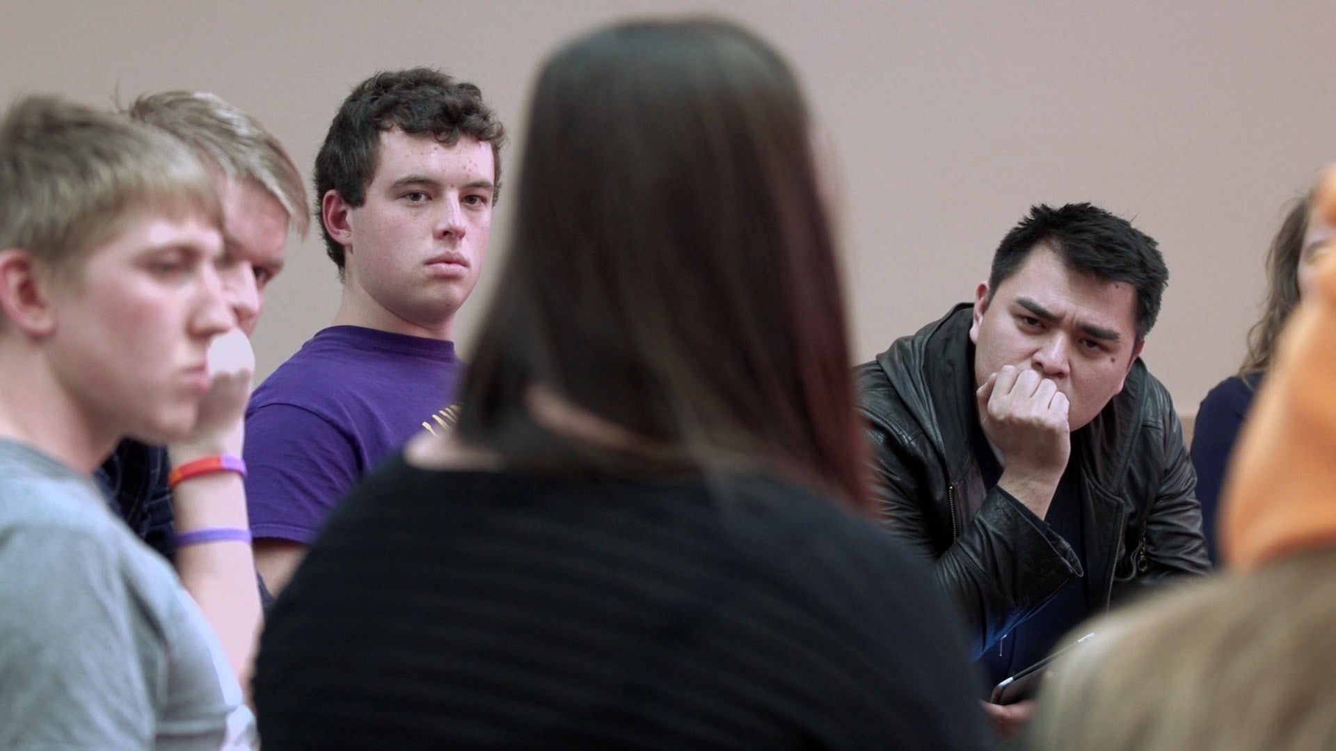 Filmmaker Jose Antonio Vargas, right, listens to a group of young people during the filming of his documentary "White People."