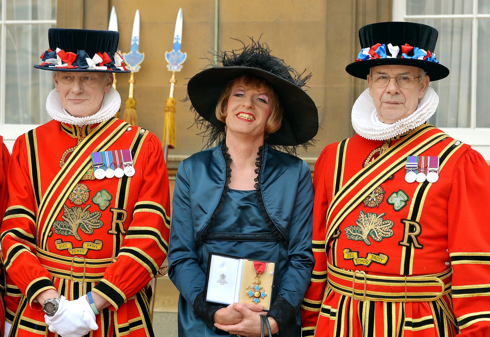 What does he have in mind for the Beefeaters? Grayson Perry, who wants to install ceramic puppies at the Tower of London, accepting a CBE at Buckingham Palace