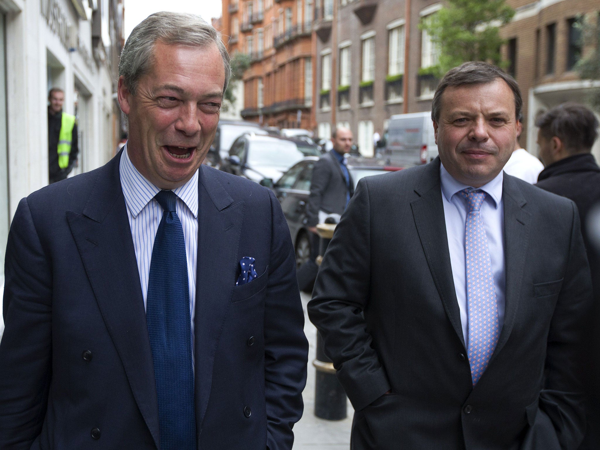 UK Independence Party (UKIP) leader Nigel Farage (L) and major donor Arron Banks leave the party's head office in central London on 15 May 2015.