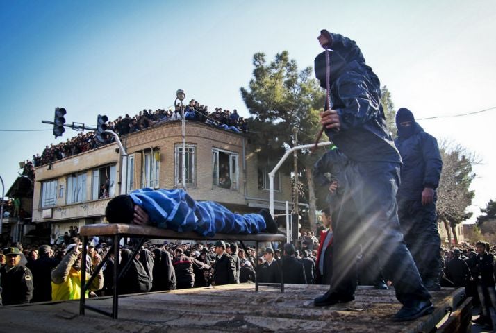 An Iranian officer lashes a man, convicted of rape, at the northeastern city of Sabzevar