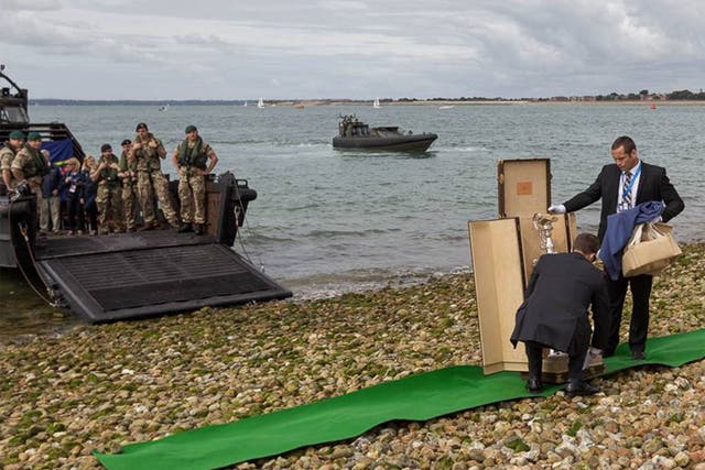 Green Berets deliver the America's Cup to the beach at Southsea ahead of the World Series racing to be staged on Saturday and Sunday with Britain’s Land Rover BAR team sitting in the favourite's chair