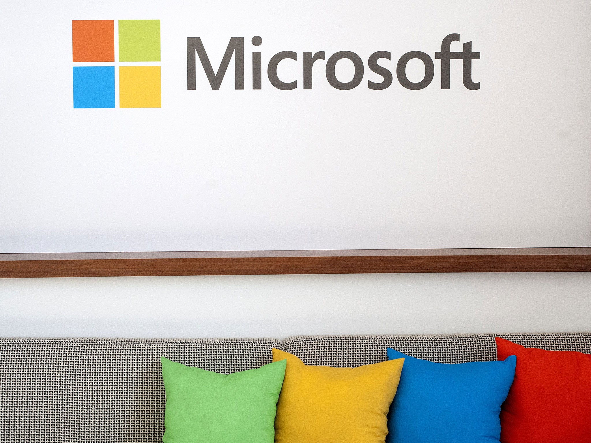 The Microsoft logo is seen before the start of a media event in San Francisco, California on Thursday, March 27, 2014. Satya Nadella, CEO of Microsoft, unveiled a version of Office designed for the iPad today. Microsoft is tapping into its software past a