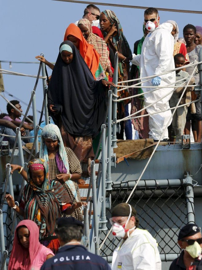 Migrants disembark from the German navy vessel Schleswig Holstein in the Sicilian harbour of Augusta