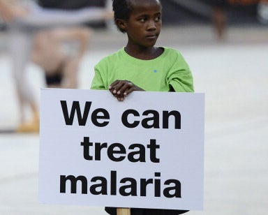 A young girl silently pleads for help fighting malaria at a Cup of Nations match in South Africa in 2013