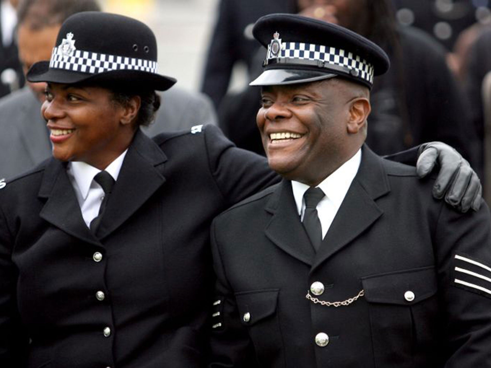 Keith Jarrett (right) shares a laugh with an unidentified police officer during the march on Stapleton Road in Bristol