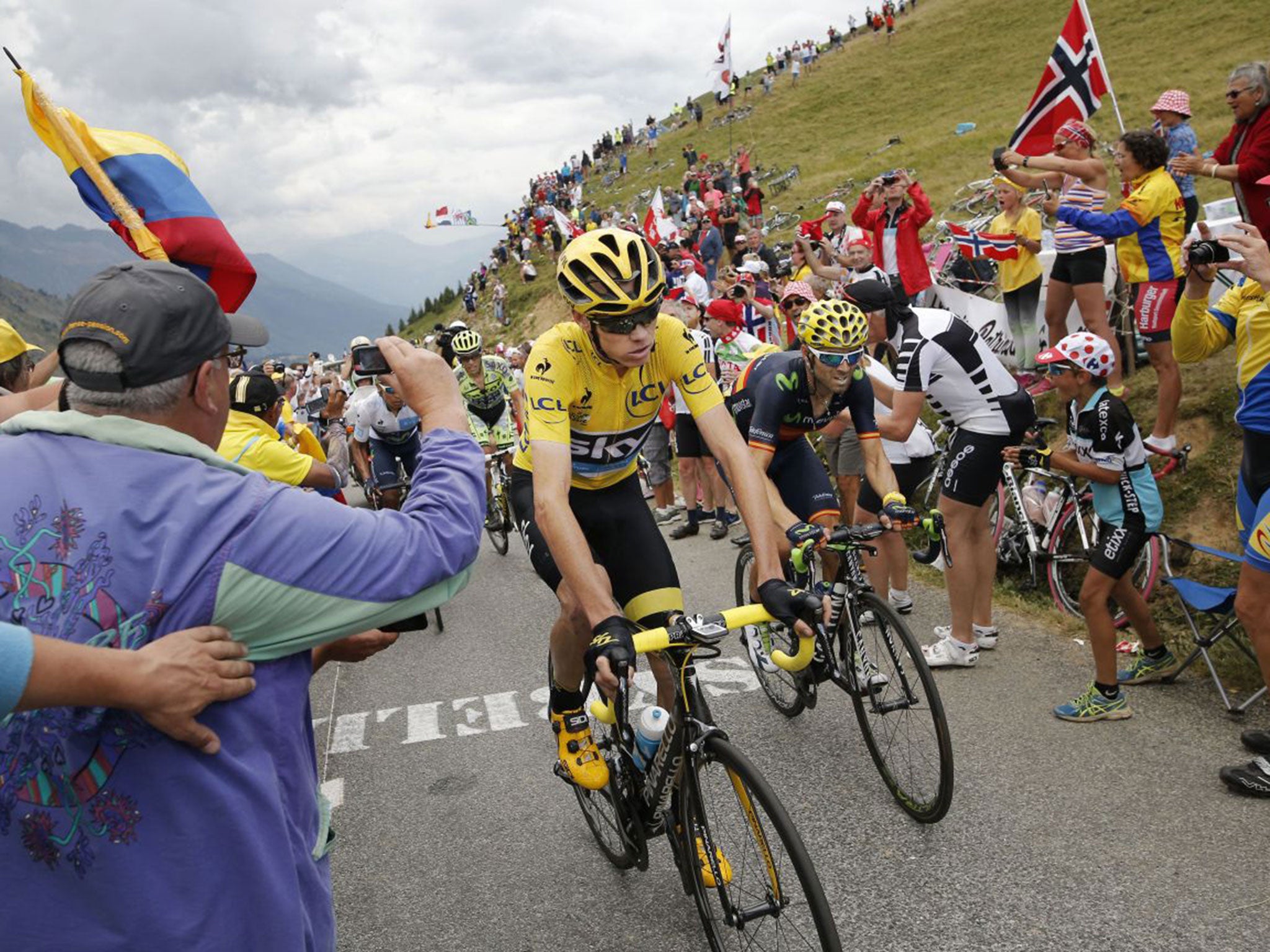 Chris Froome, wearing the leader’s yellow jersey, climbs Croix de Fer pass during the 19th stage of the Tour de France