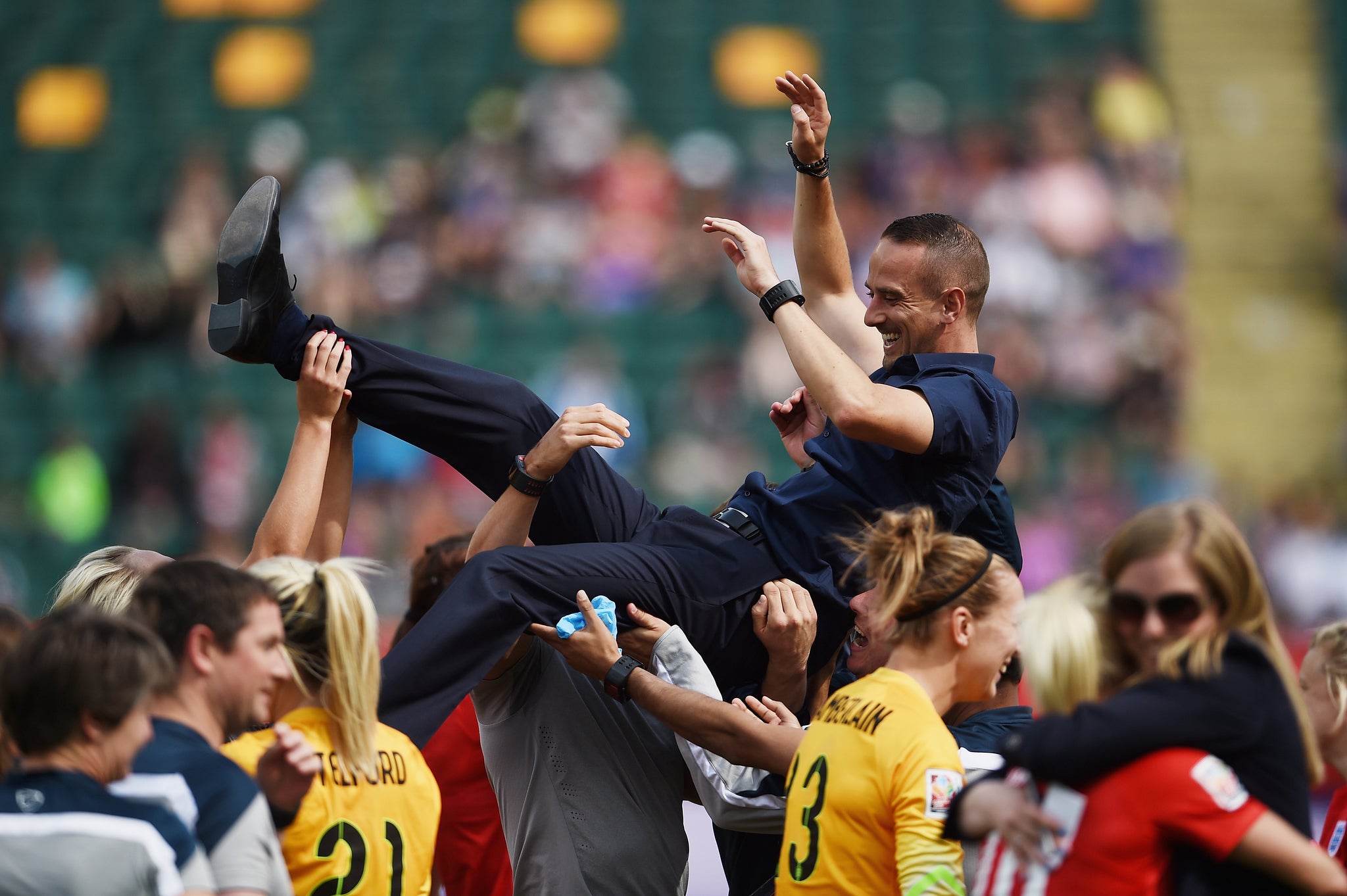Mark Sampson is thrown in the air as England celebrate their third-place play-off win over Germany in Edmonton earlier this month