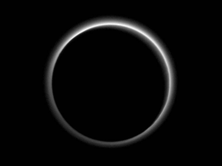 This image of Pluto clearly shows the planet's atmosphere being illuminated by the sun's rays