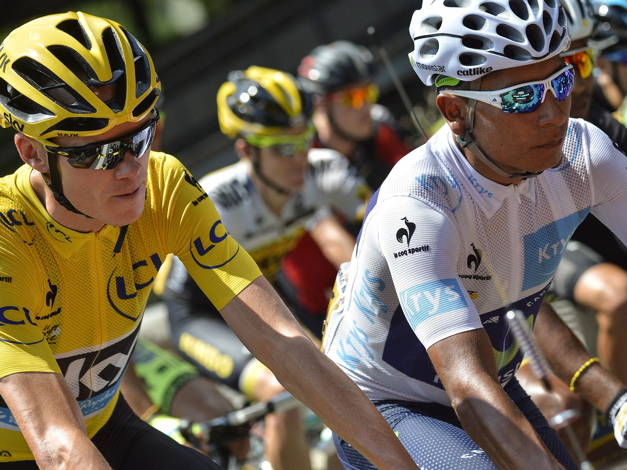 Christopher Froome (L), wearing the overall leader's yellow jersey, and Colombia's Nairo Quintana at the start of stage 19