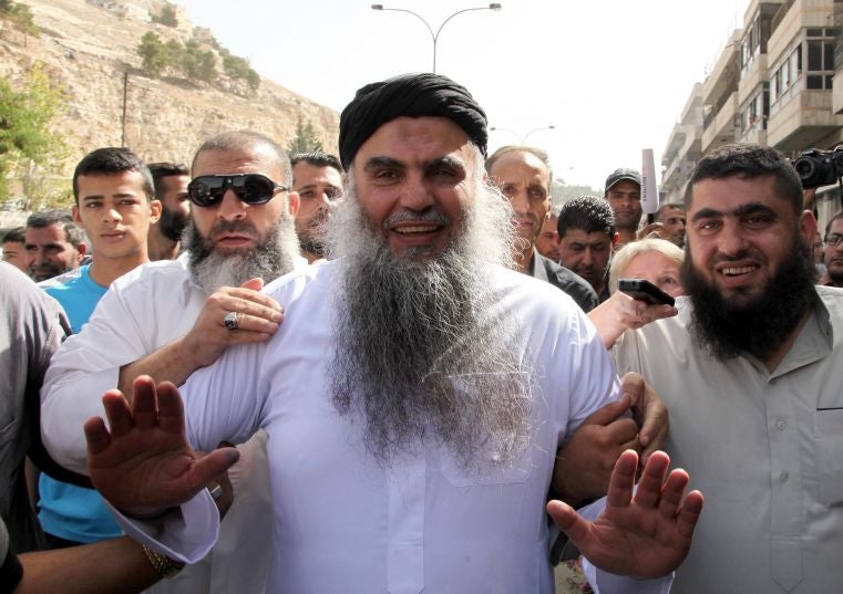 80 Radical Islamist cleric Omar Mahmoud Othman (C), also known as Abu Qatada, arrives at his home after a court acquitted him of terrorism-related charges, in Amman, Jordan, 24 September 2014