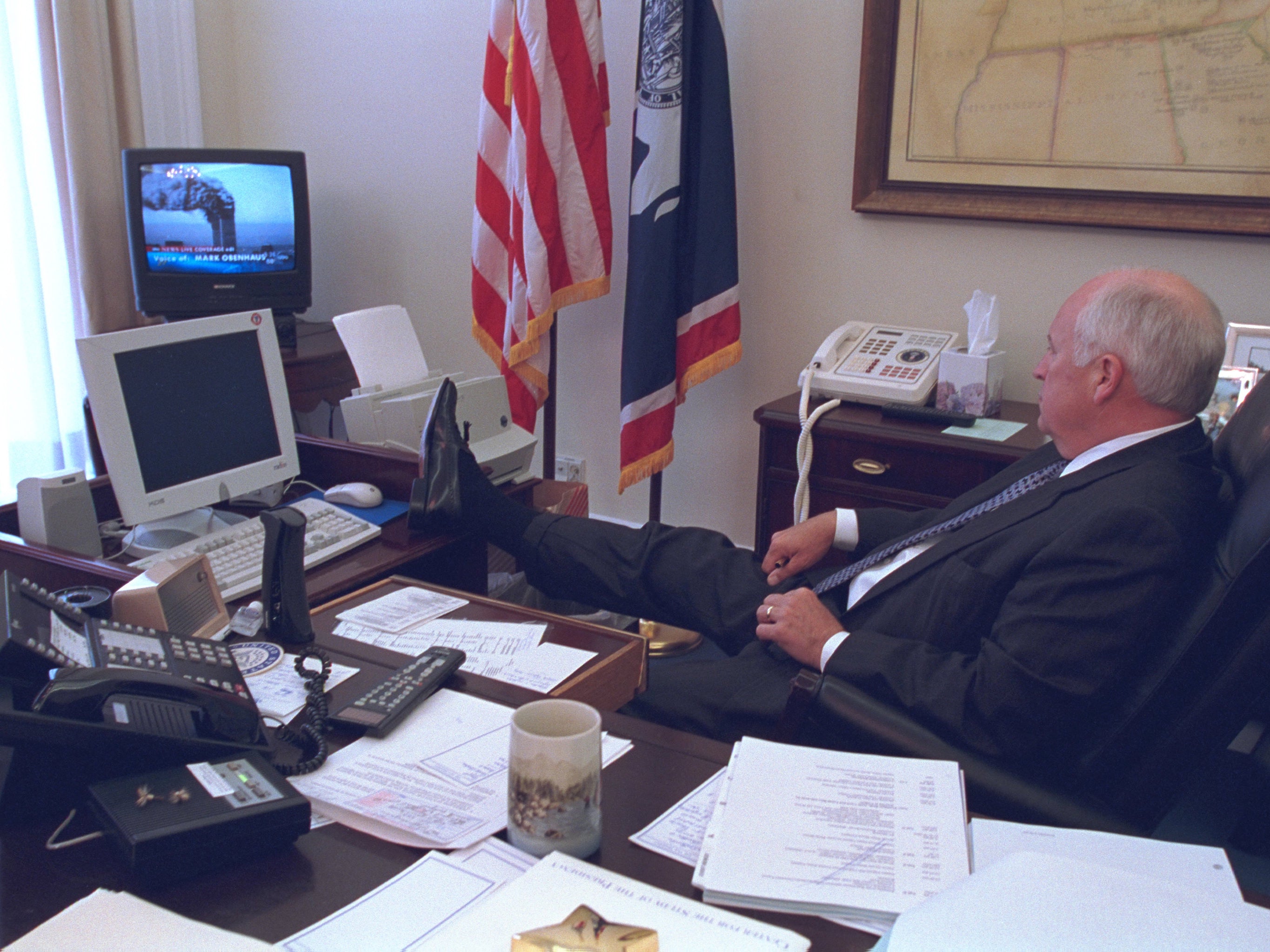 Vice-President Dick Cheney rests his feet while watching news coverage of the Twin Tower attacks