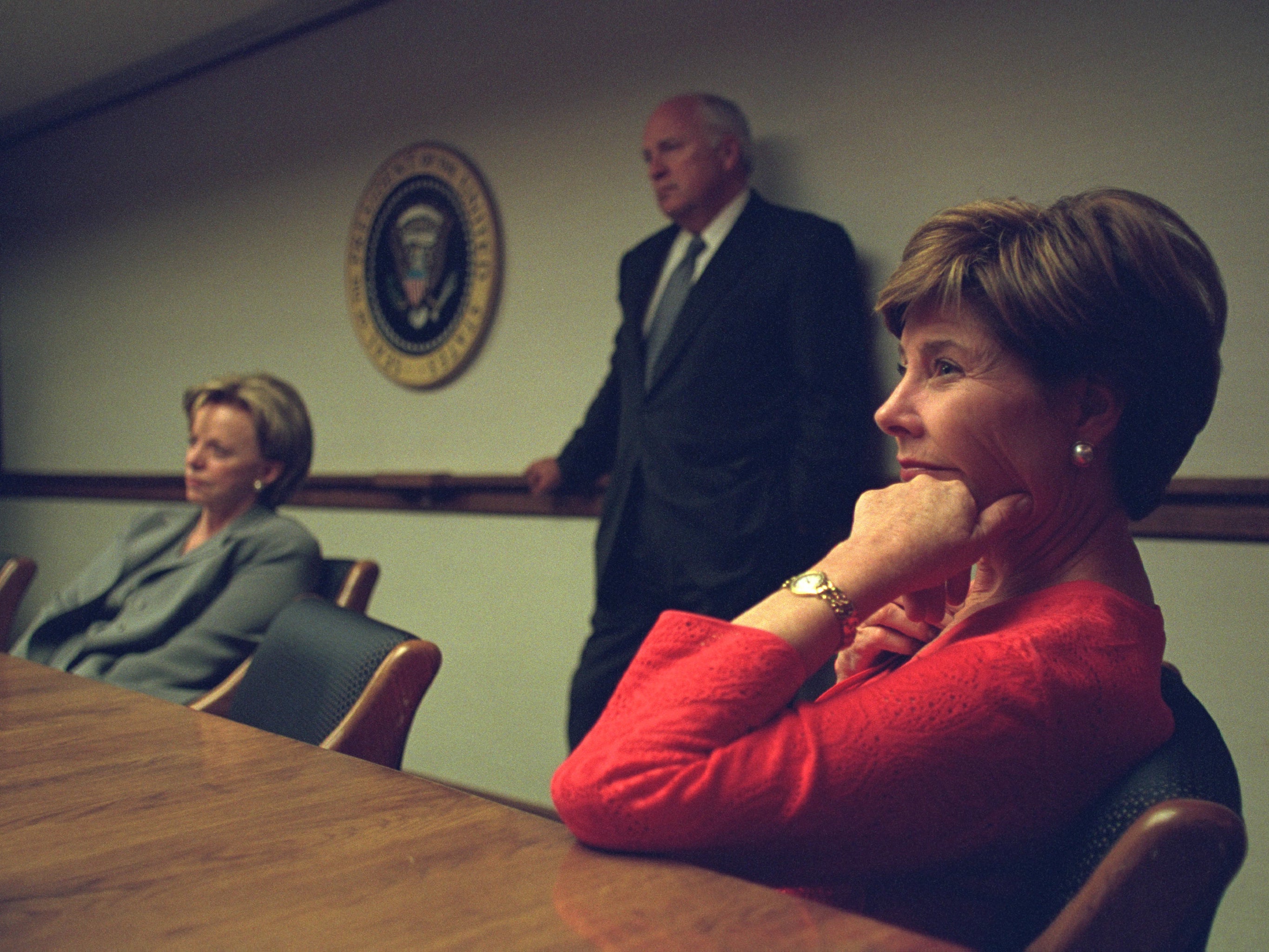 Laura Bush, Lynne Cheney and Dick Cheney sit in the Emergency Operations Centre