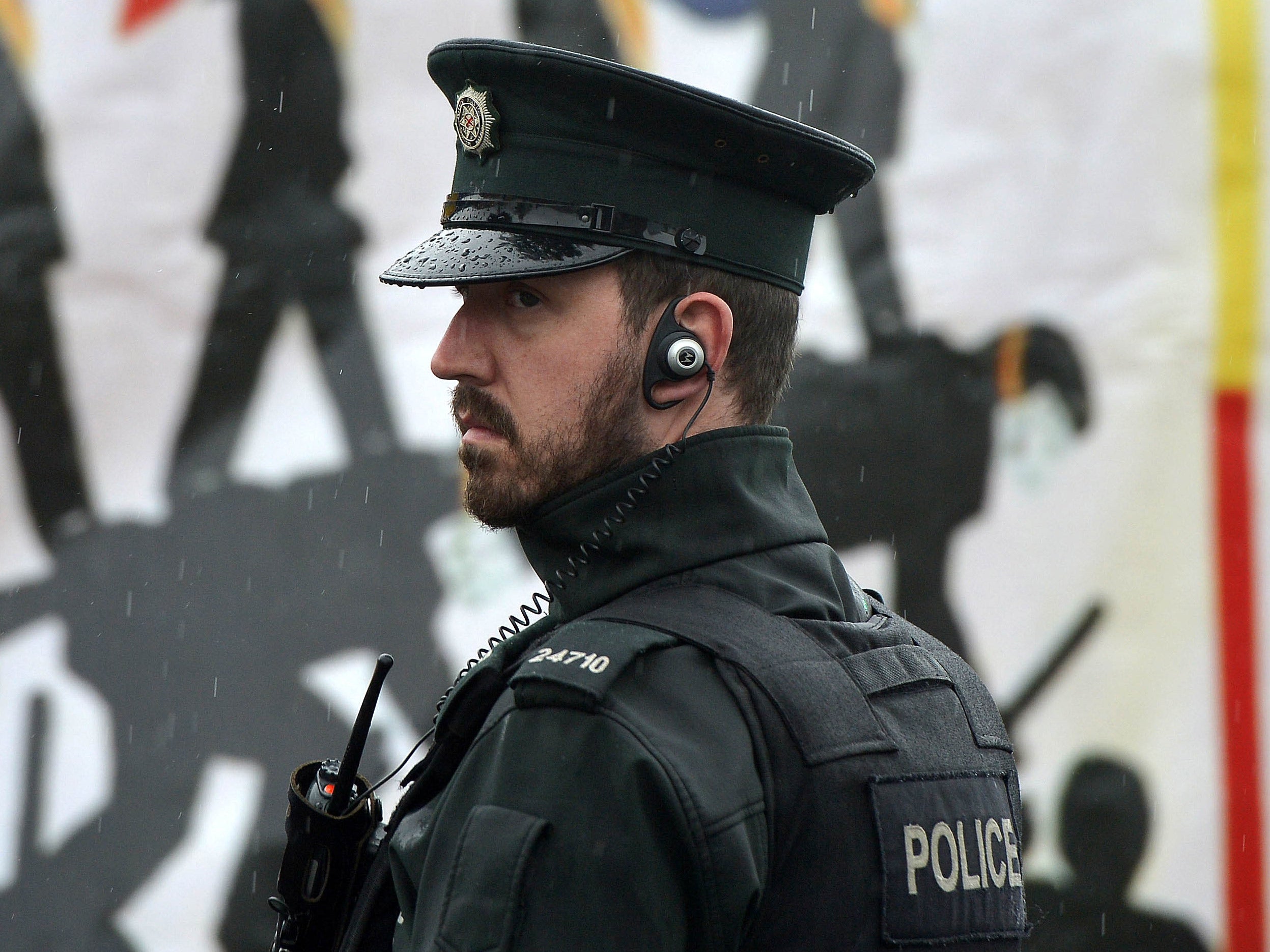 File image: A member of the Northern Ireland police force patrols in the nationalist Ardoyne area