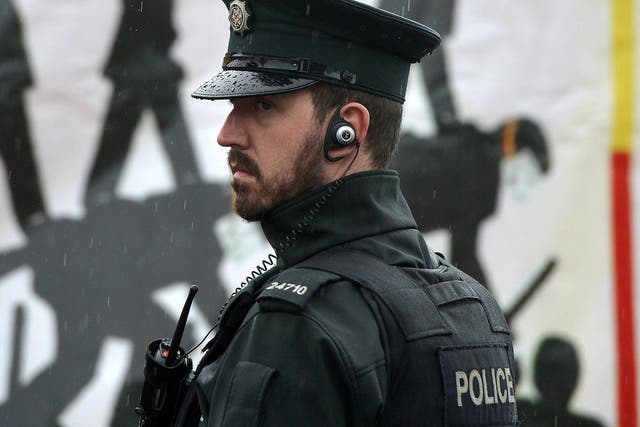File image: A member of the Northern Ireland police force patrols in the nationalist Ardoyne area