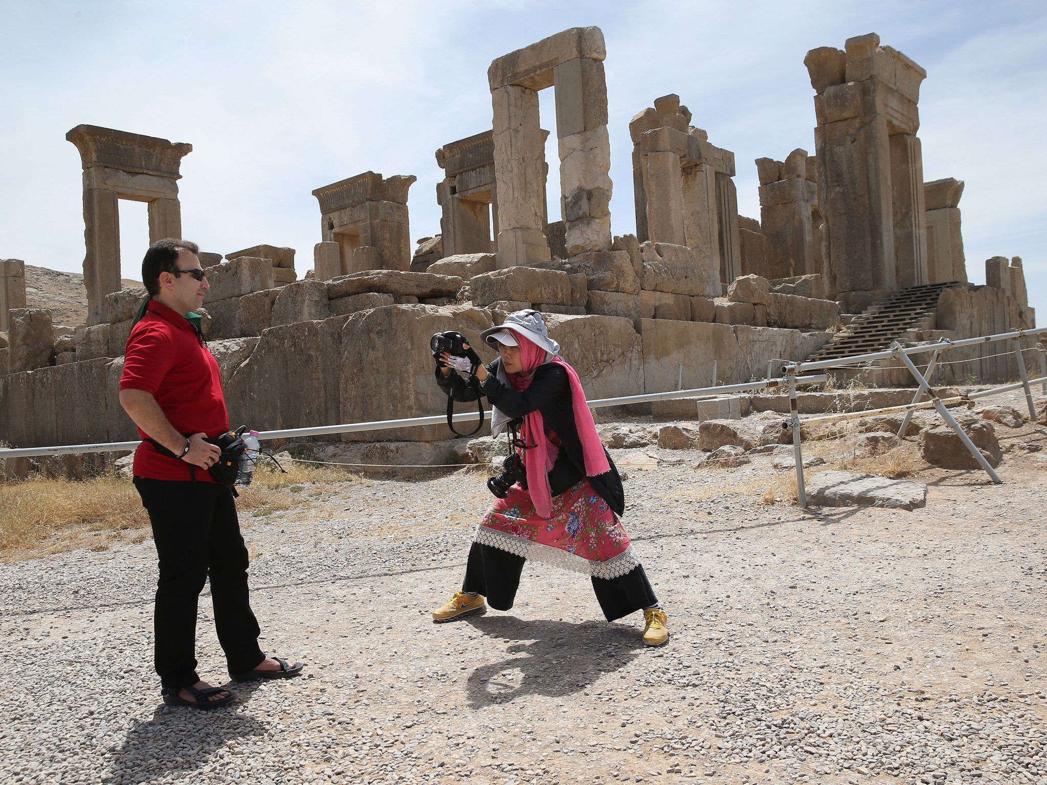 A Taiwanese tourist photographs a man at Persepolis in Iran in 2014
