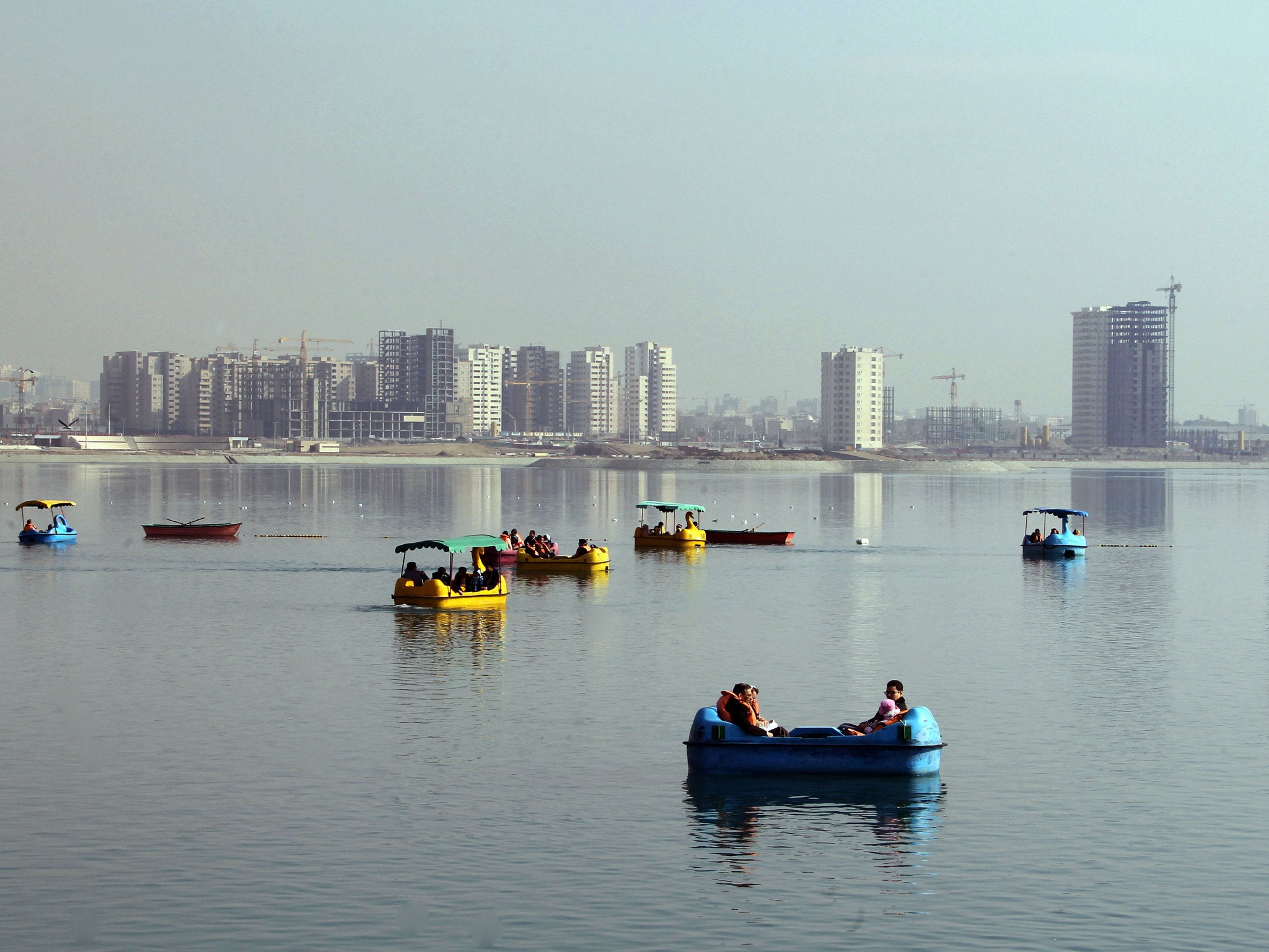 Iranian families riding pedal boats on Chitgar lake in western Tehran