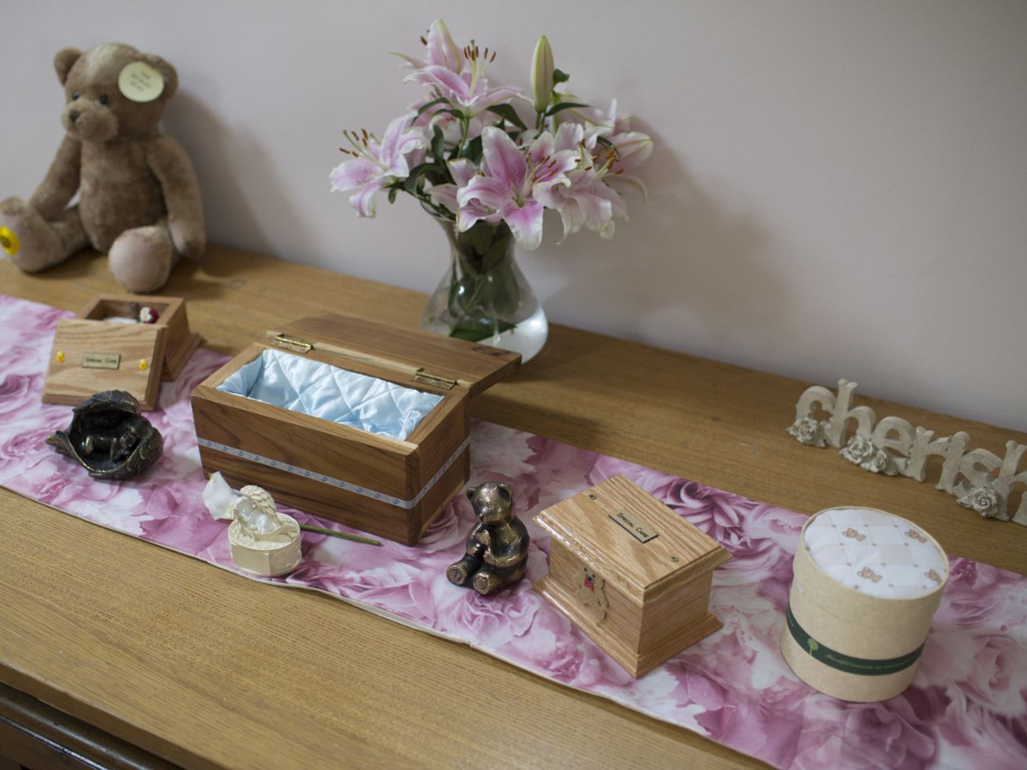 The chapel for Angel is already prepared, with oak pews and scented candles. On the table, there are tiny, silk-lined oak coffins the size of jewellery boxes, empty and ready for use