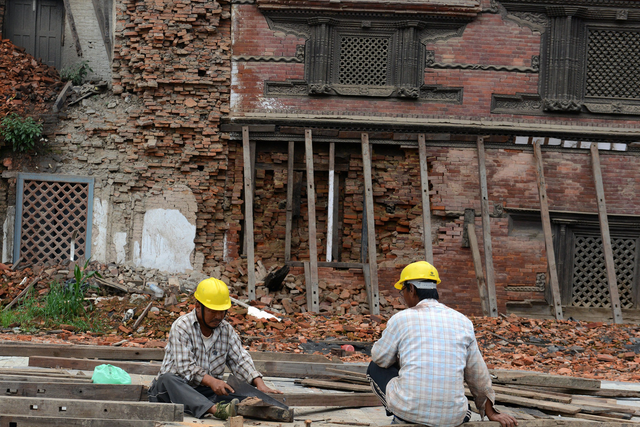 Workers renovate heritage sites in Basantapur Durbar Square in Kathmandu on July 21, 2015 that were destroyed by earthquakes in April and May