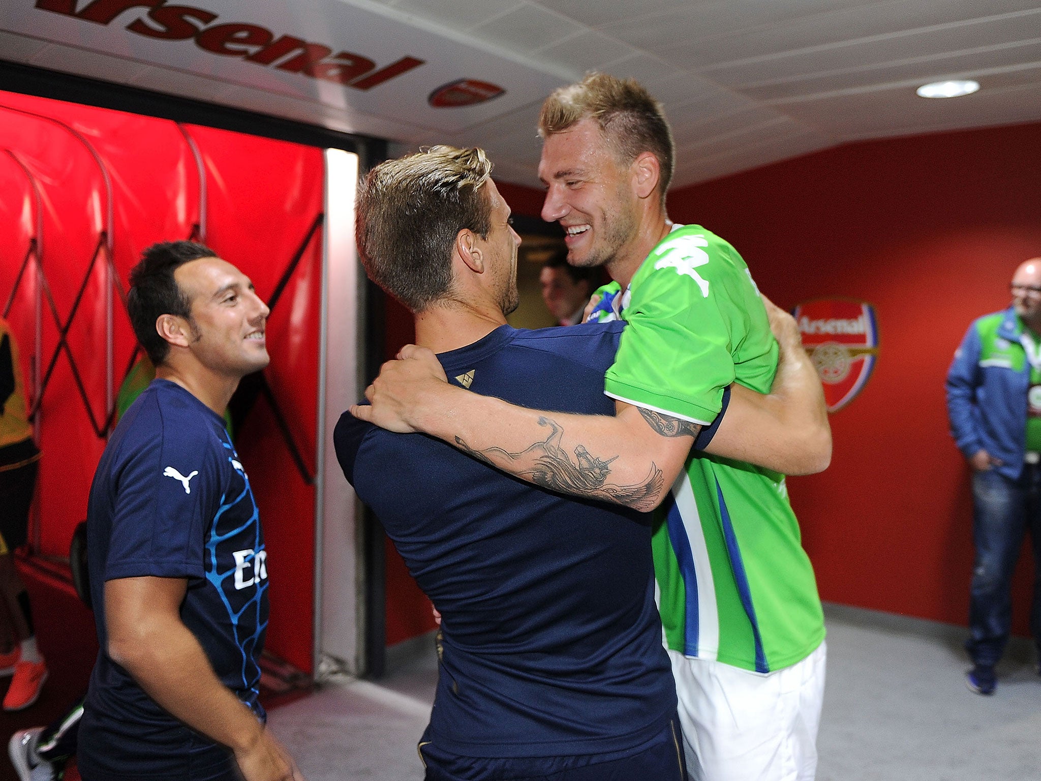 Nicklas Bendtner greets former team-mate Nacho Monreal before Arsenal face Wolfsburg
