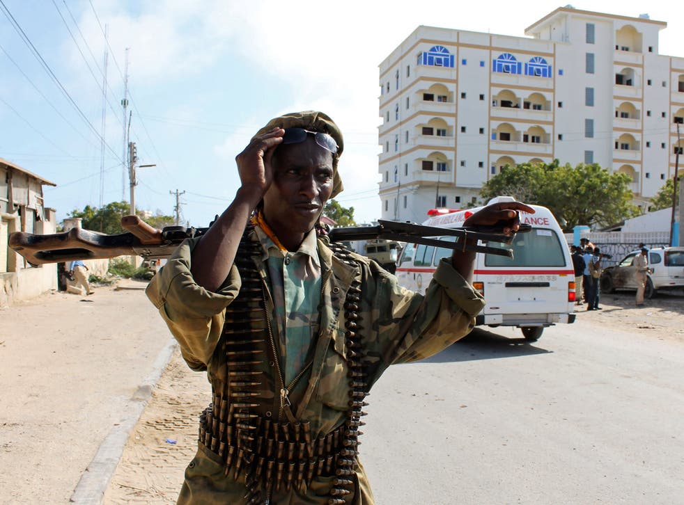 File image: A Somali soldier patrols outside the Jazeera Palace hotel