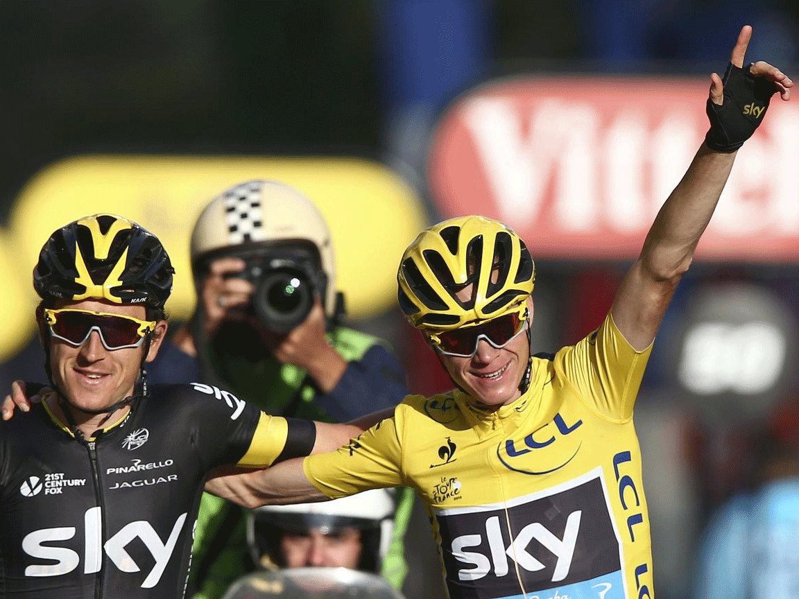 Chris Froome, wearing the overall leader's yellow jersey, rides arm-in-arm with teammate Britain's Geraint Thomas as he crosses the finish line of the twenty-first and last stage of the Tour de France