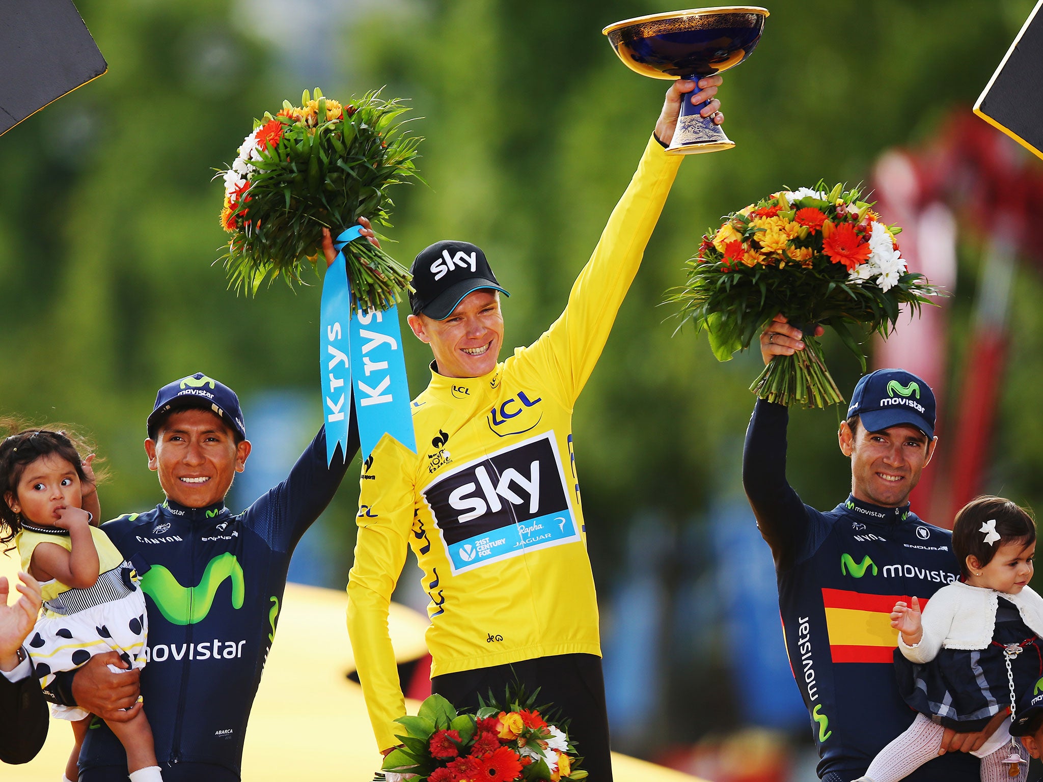 Tour de France winner Chris Froome, centre, celebrates alongside second placed Nairo Quintana, left, of Colombia and third placed Alejandro Valverde, right, of Spain