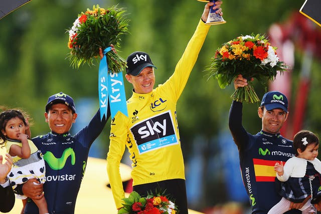 Tour de France winner Chris Froome, centre, celebrates alongside second placed Nairo Quintana, left, of Colombia and third placed Alejandro Valverde, right, of Spain 