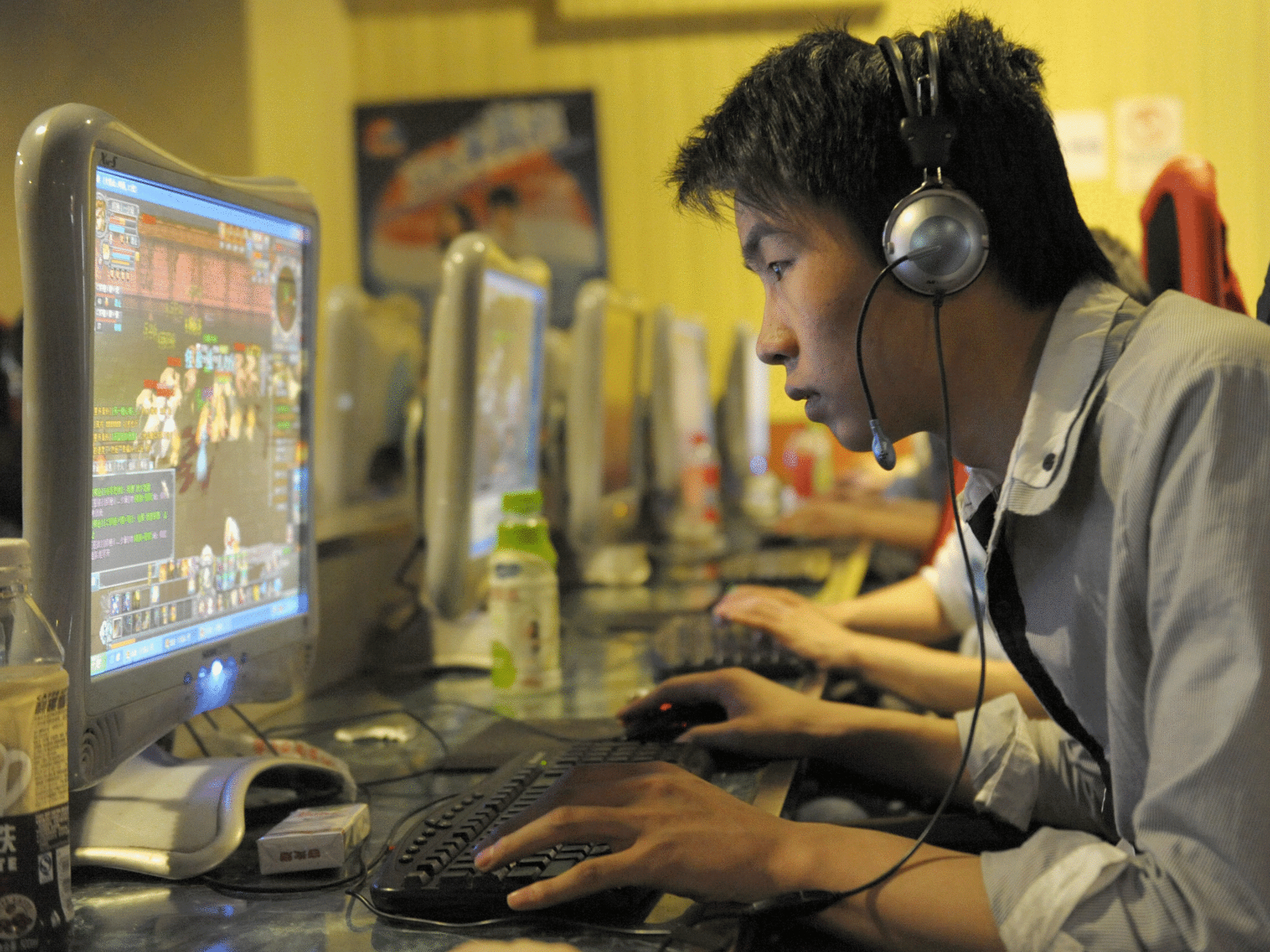 A chinese man plays online games at an internet cafe in Beijing