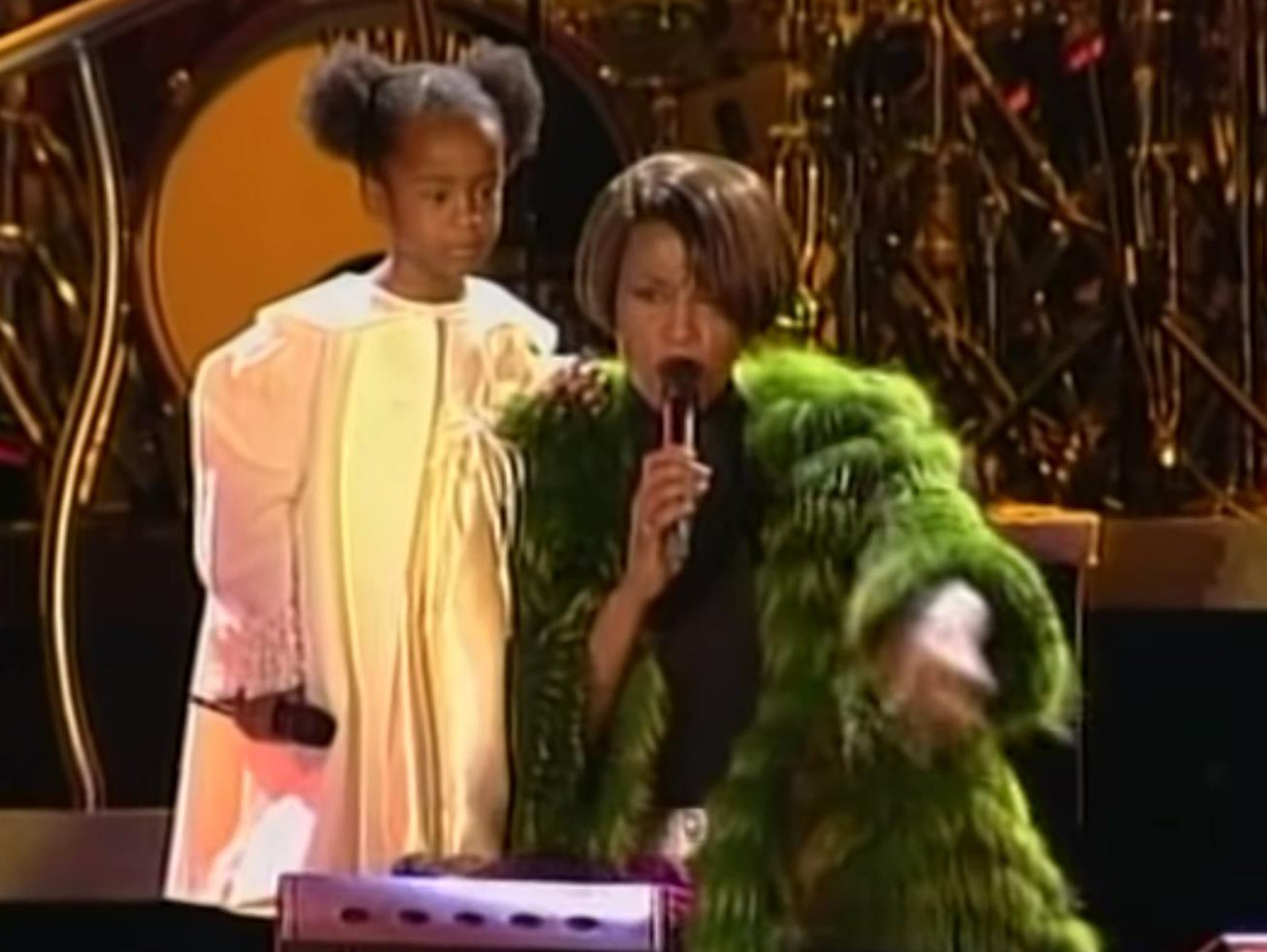 Bobbi Kristina Brown and Whitney Houston perform on stage together in 1999