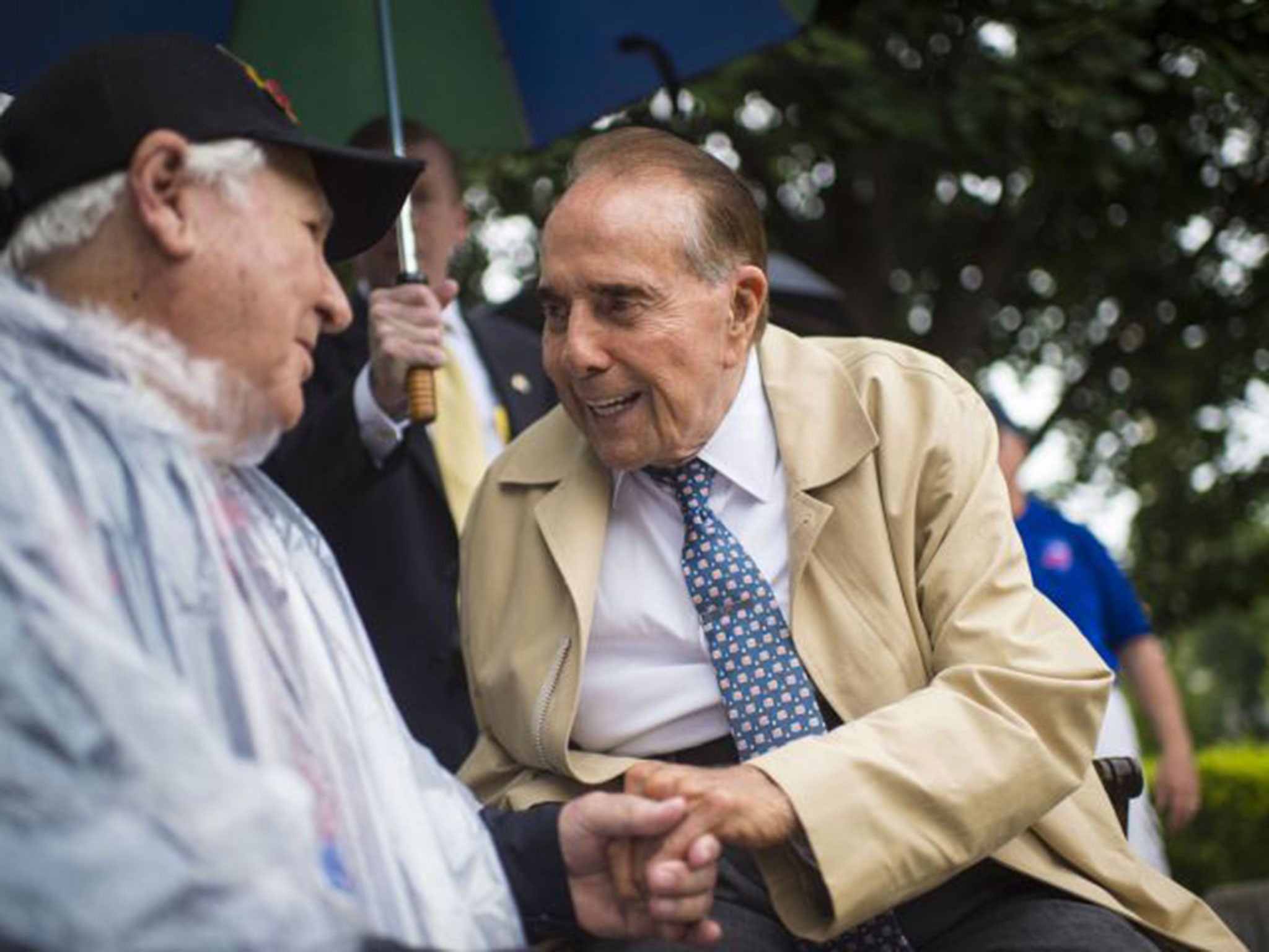 Former senator and World War II veteran Bob Dole, who served under Dwight D. Eisenhower, greets veterans and tourists at the National WW II Memorial to try and raise awareness for a possible Eisenhower Memorial