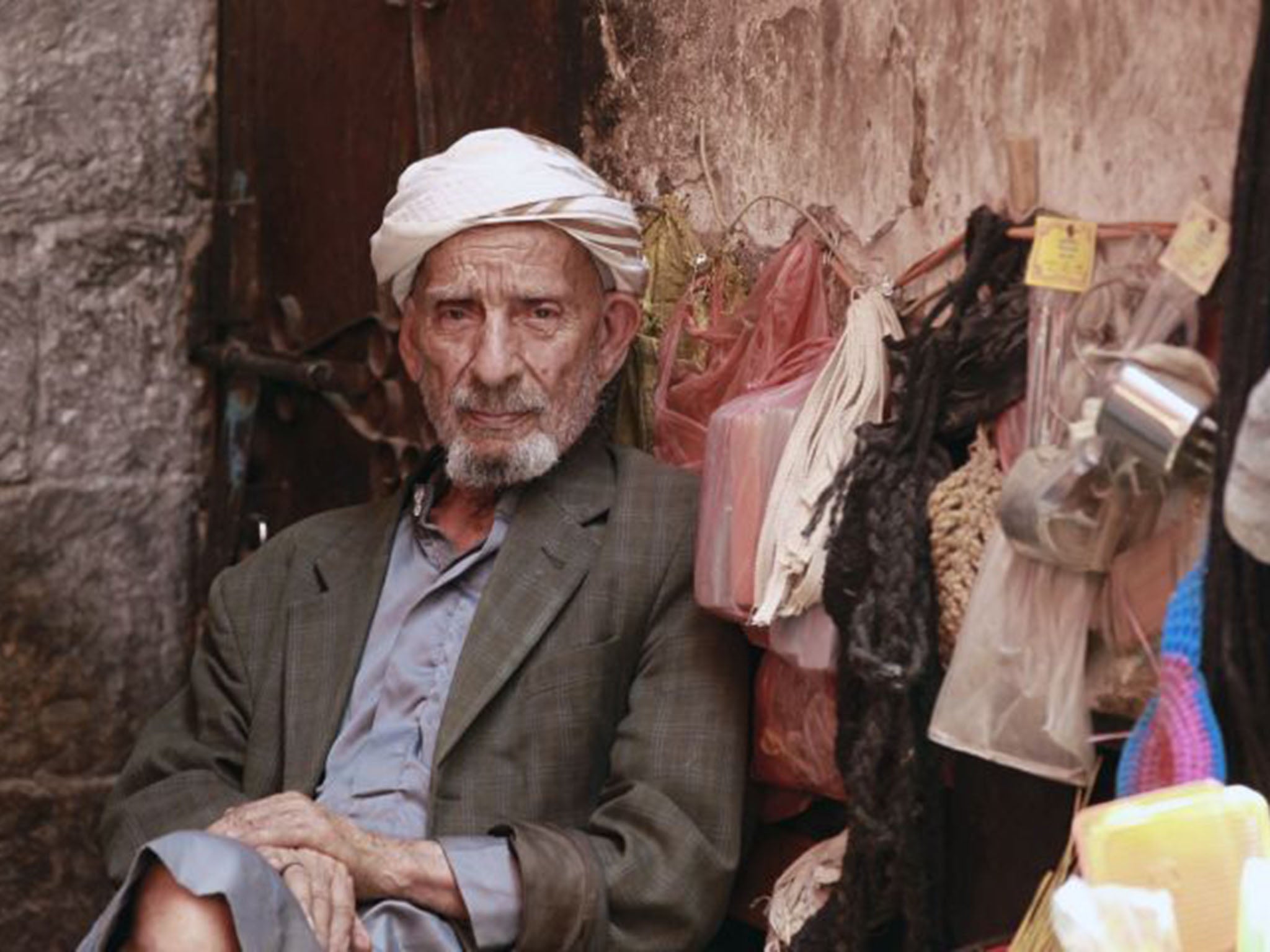 A Yemeni man sits at a stall at a market in the capital Sanaa's old city on July 27, 2015.