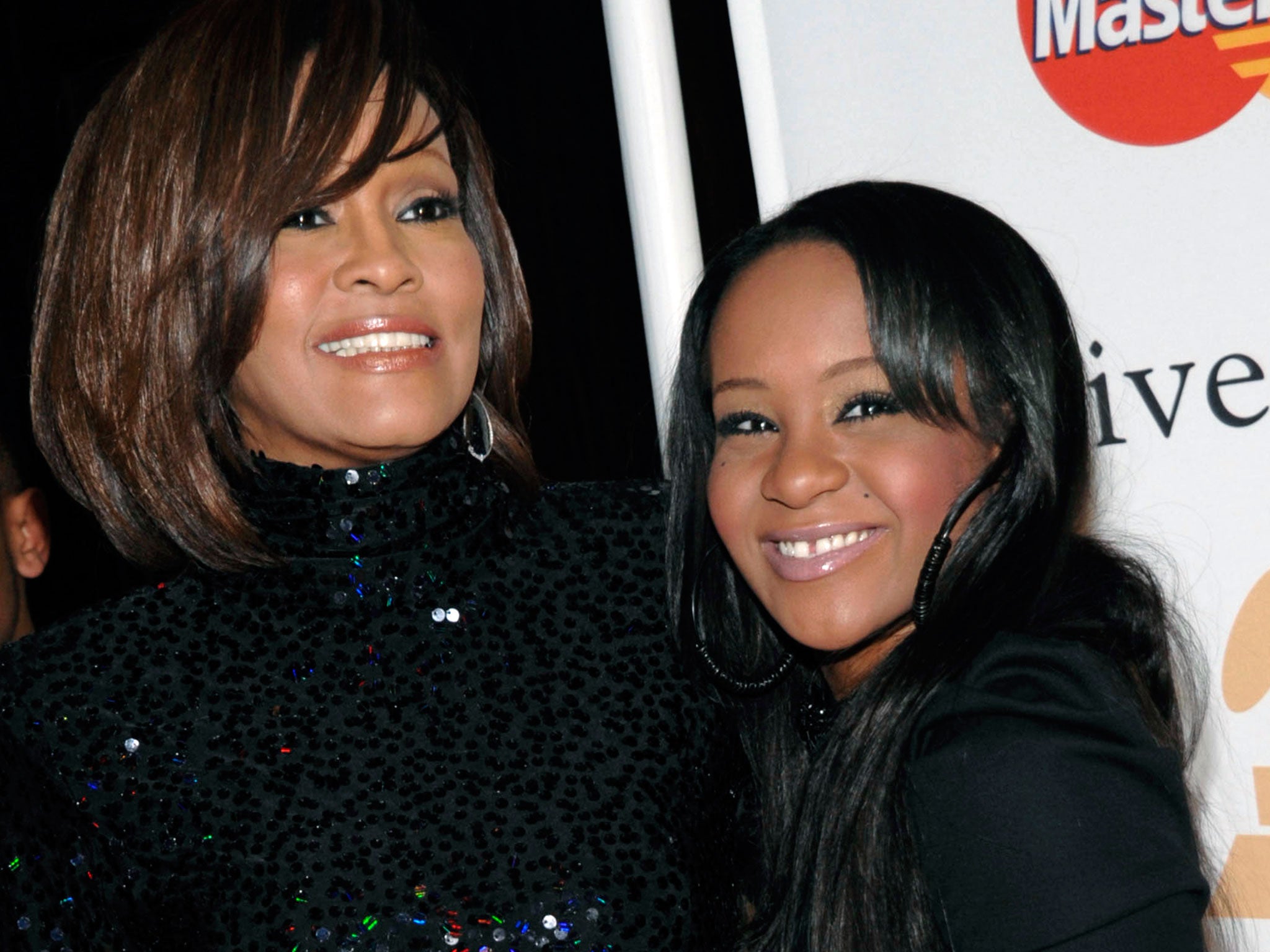 Whitney Houston, left, and daughter Bobbi Kristina Brown arrive at an event in Beverly Hills in 2011