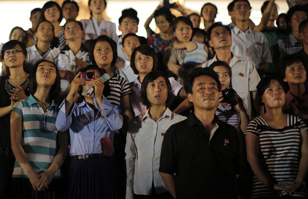 North Koreans watch a firework display put on to celebrate the armistice day