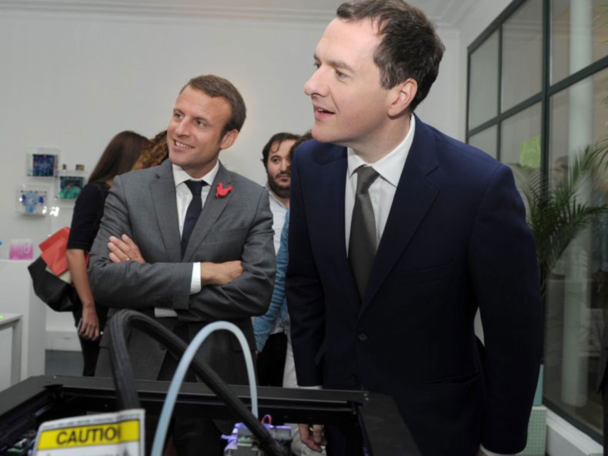 George Osborne and Emmanuel Macron listen to explanations during a visit of the French start-ups incubator and accelerator (EPA)