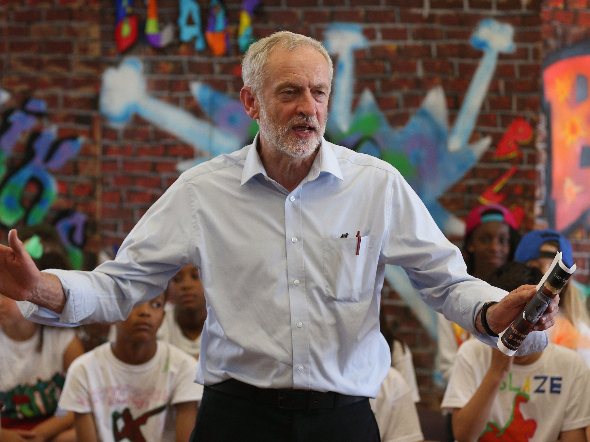 Jeremy Corbyn presents pupils with certificates after they perform in a play on their last day of school at Duncombe Primary School in London
