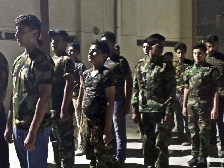 Teenage boys were seen training with the PMF in Baghdad on 14 July