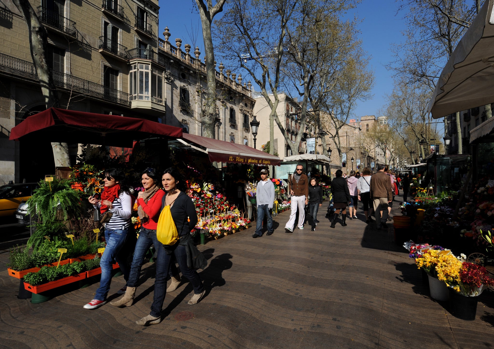 Tourists stroll down the famous Las Ramblas in Barcelona, near to where the shooting occured