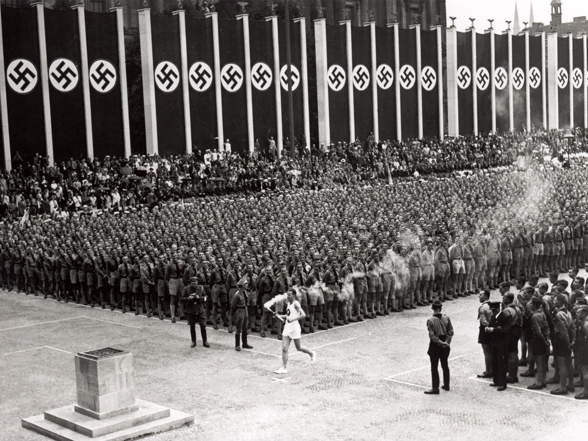 The Olympic torch is carried into the stadium during the opening ceremony of the 1936 Games in Berlin (Getty)