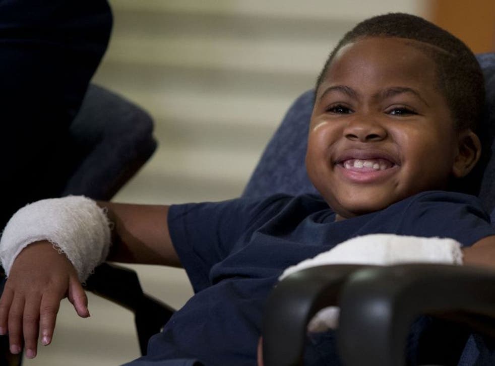 Double-hand transplant recipient eight-year-old Zion Harvey smiles during a news conference Tuesday, July 28, 2015, at The Childrenís Hospital of Philadelphia (CHOP) in Philadelphia. Surgeons said Harvey of Baltimore who lost his limbs to a serious infect