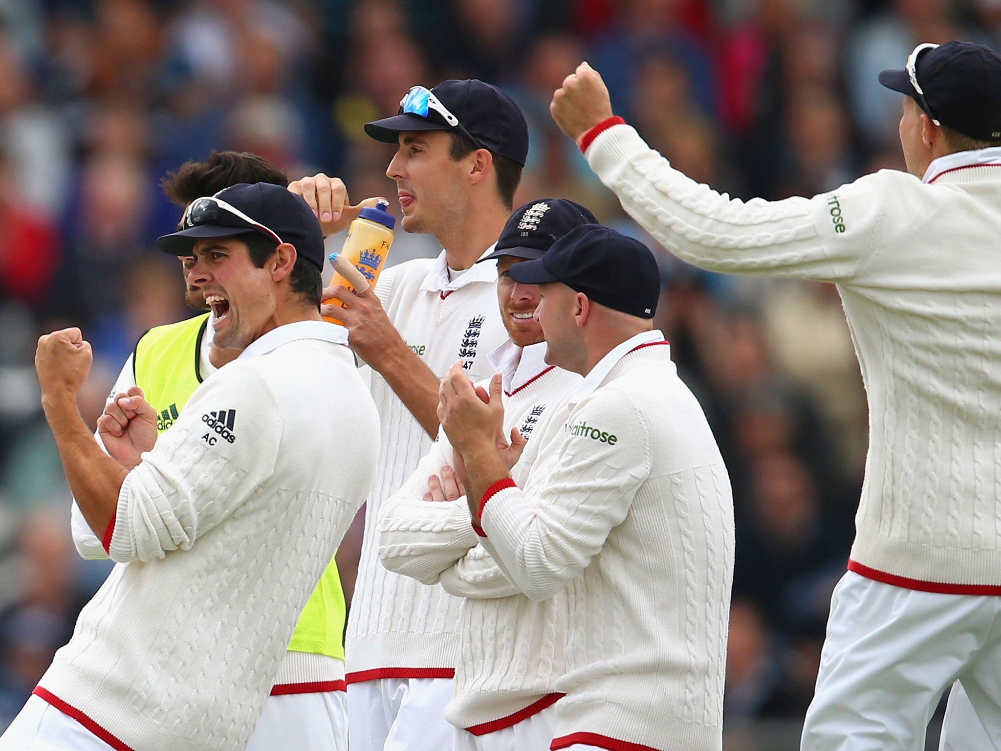 Alastair Cook leads the celebrations as the third umpire confirms Warner's wicket