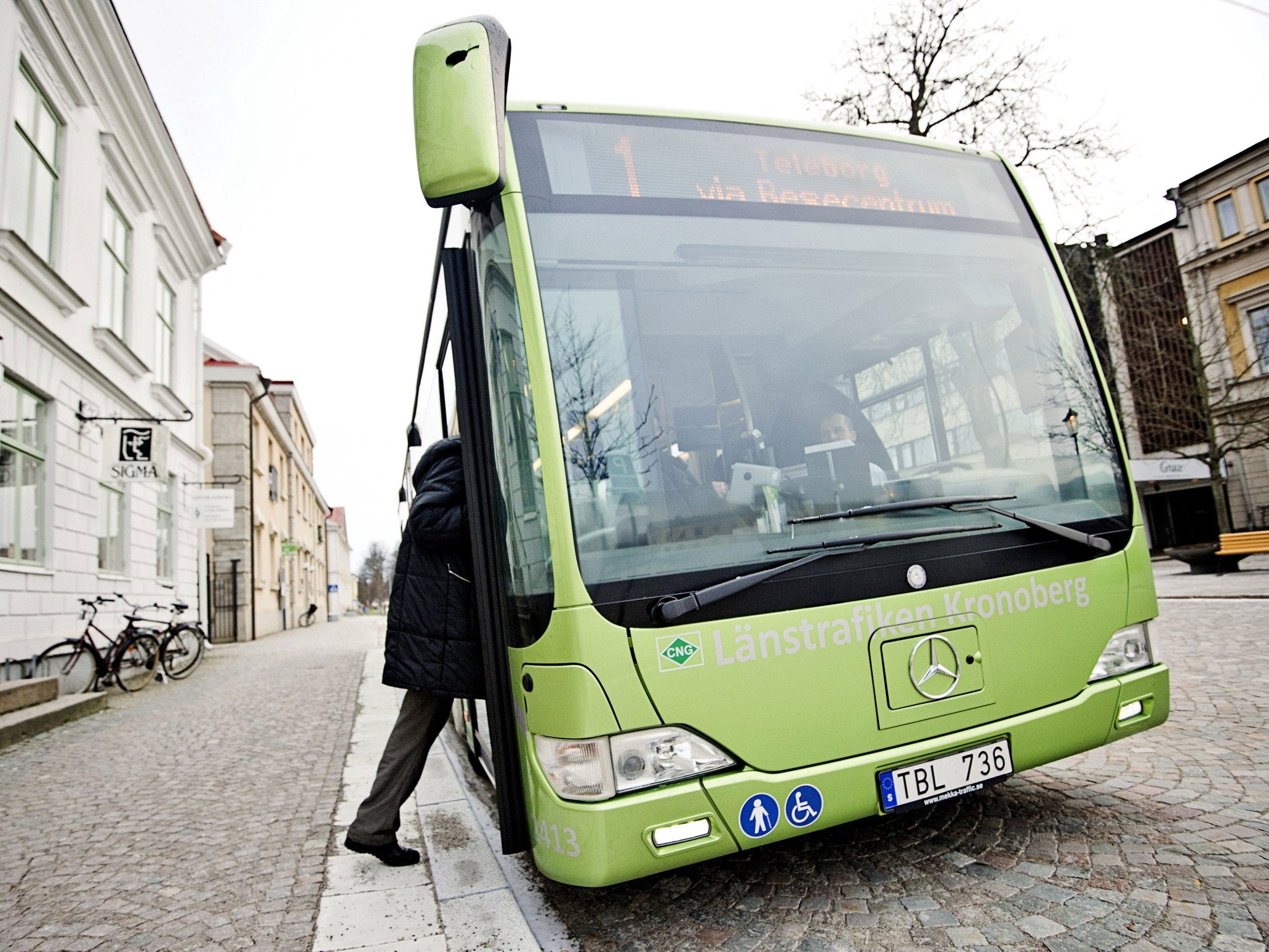 A passenger boards a bus in Växjö, Sweden