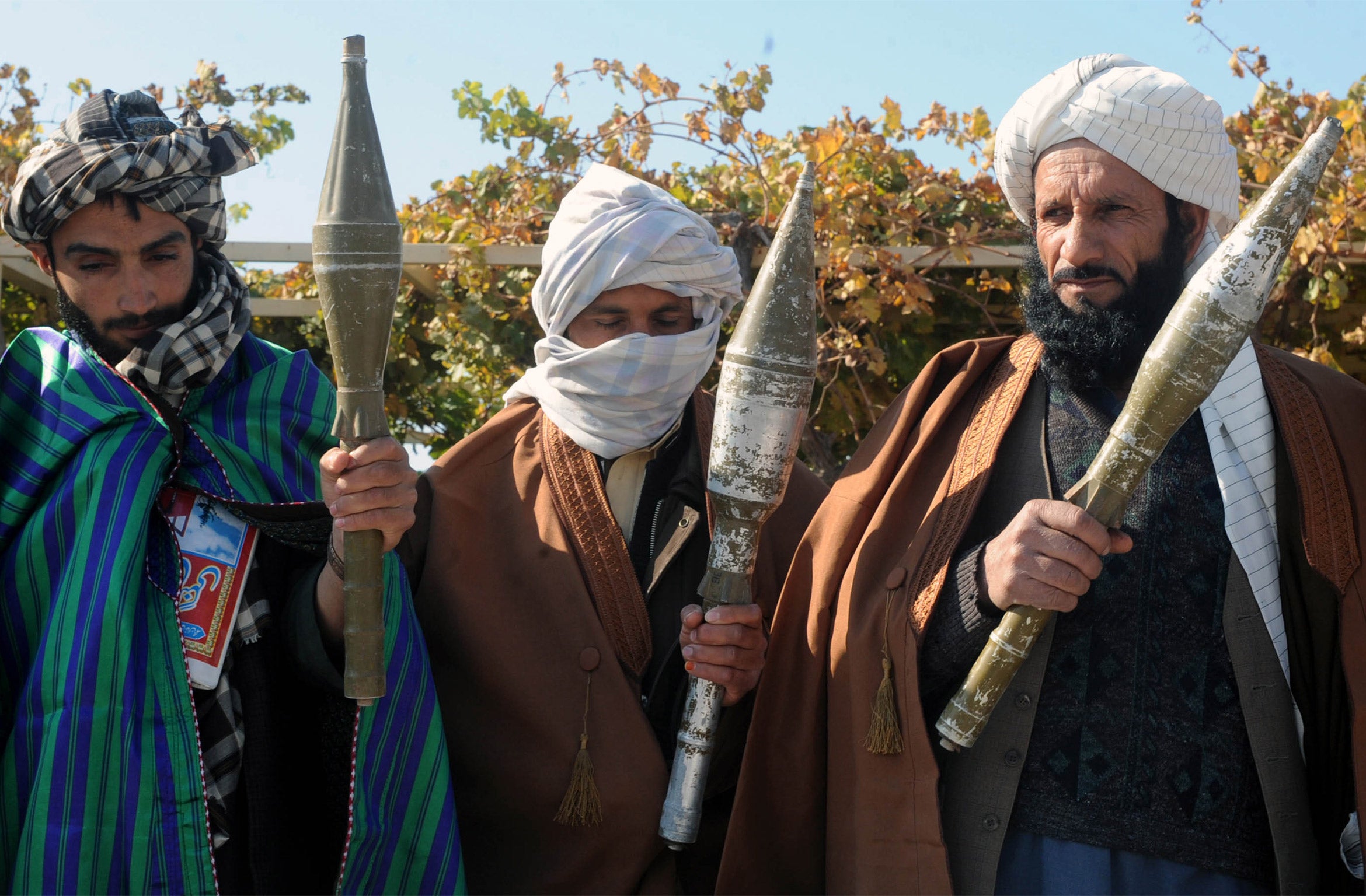 Former Taliban fighters display their weapons after they joined Afghan government forces in 2012 (Getty)