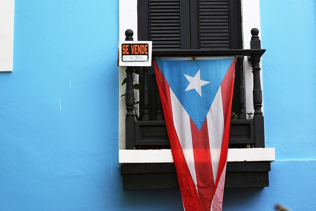 Puerto Rico has an outstanding debt of $72bn. Economists say the country should shrink the size of the state rather than default on repayments 