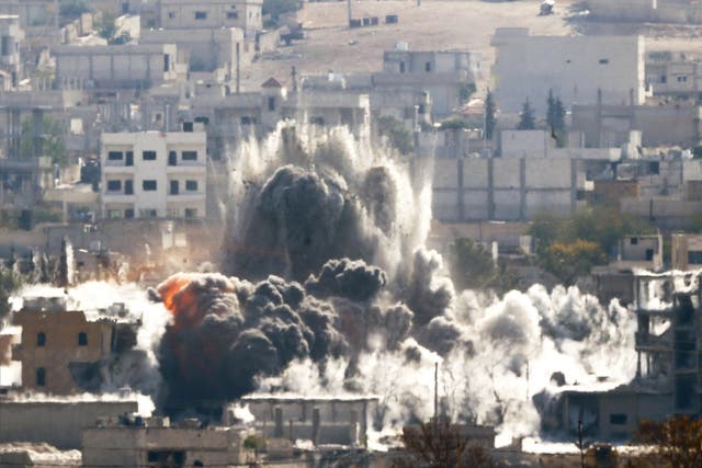 An explosion following an air-strike is seen in the Syrian town of Kobani last year