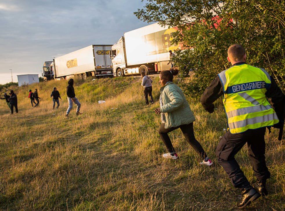 Migrants attempting to board lorries near the Eurotunnel