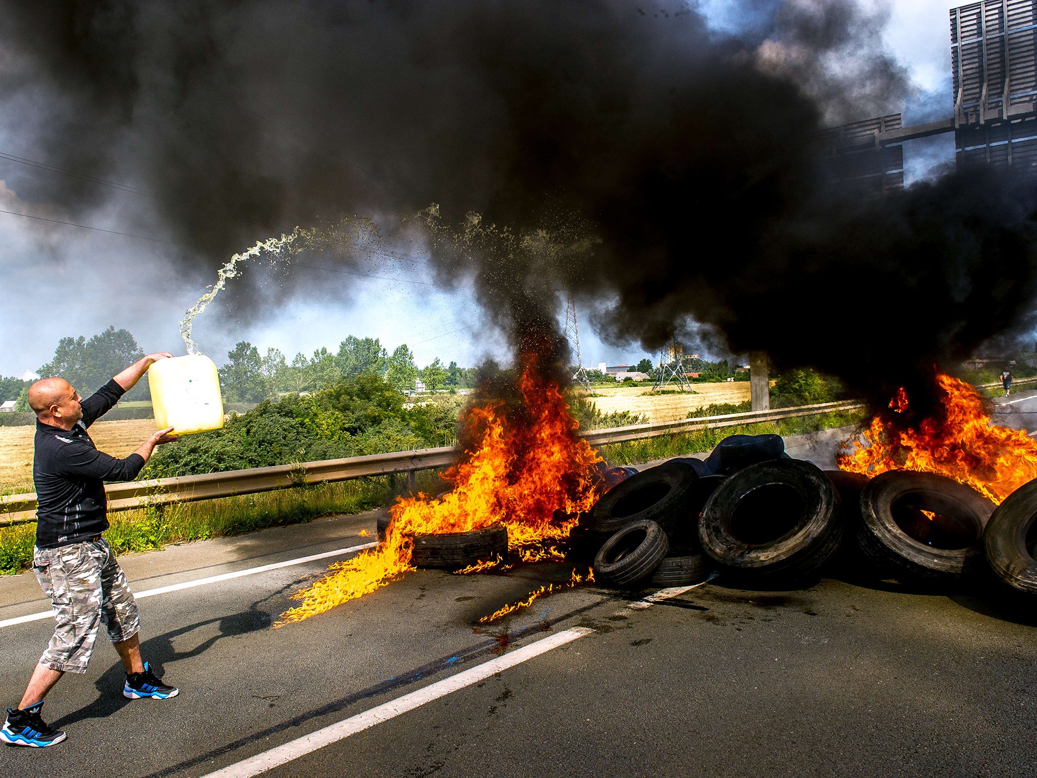 Striking employees of the My Ferry Link company burn tyres as they block the access to the harbour in Calais